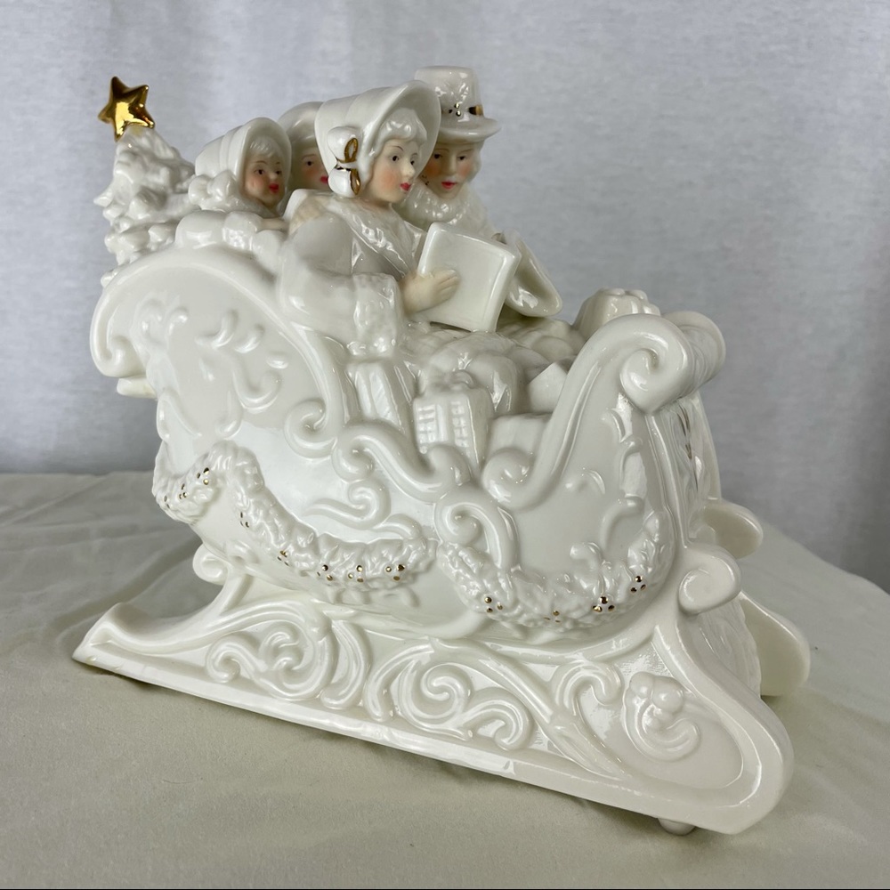 Vintage music box sculpted in a sleigh with caroling family